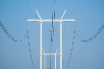Hydro electric poles with wires on a blue sky