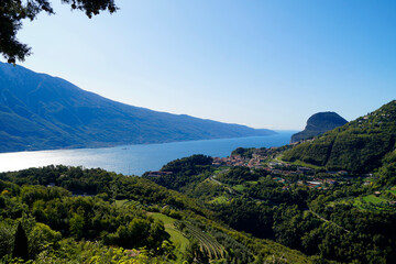 a sunlit mediterranean scenery of turquoise lake Garda with mountains in the background (Italy, Lombardy)