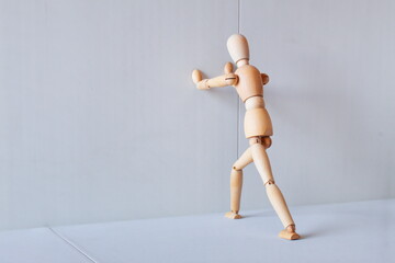 Wooden figure showing a position of stretching muscles to exercise