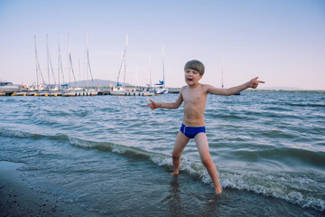 kid playing at the lake