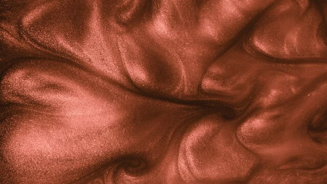 Super Slow Motion Shot of Bronze Glittering Fluid Background at 1000fps.