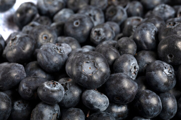 Macro close up of unwashed blueberries.