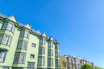 Fototapeta premium Row of apartment buildings in a low angle view at San Francisco, California