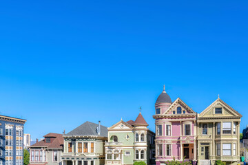 Houses with victorian style exterior against the blue sky in San Francisco, CA