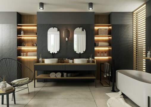 Nowoczesna, elegancka i przestronna łazienka, salon kąpielowy. We wnętrzu połączone zostały ciemne płytki na ścianach z jasnym drewnem mebli i wykończeń.