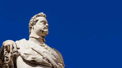 Fototapeta na wymiar Ferdinando I Medici, Grand Duke of Tuscany. A marble statue erected in 1594 in the historical center of Pisa (with blue sky and copy space)