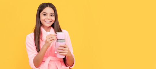 happy teen girl in home terry bathrobe with thermos bottle, hydration. Horizontal poster of isolated child face, banner header, copy space. - obrazy, fototapety, plakaty