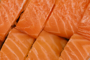 Red fish slices on sushi rolls top view. Closeup macro.