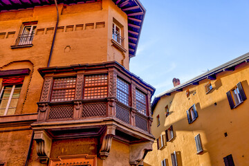 Building facades and medieval architecture along the streets in Bologna