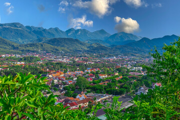 Luang Prabang Laos, beautiful river surrounded by lush green mountains and lovely historical houses