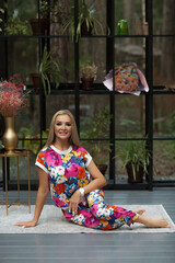 a beautiful woman in a flowers costume poses in nature