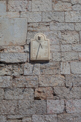 Sundial on the wall of an ancient city
