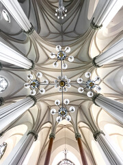 Interior details inside the church, lamps and stained-glass windows.