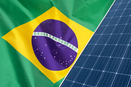 Solar panels against flag Brazil background. Solar battery generates a pure electricity. Concept of sustainable resources and renewable energy in Brazil