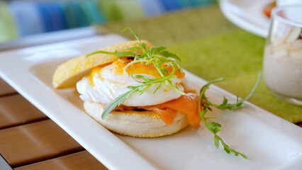 Healthy protein breakfast with delicious eggs, salad and cereal porridge. Served food in cafe. Eating eggs Benedict on lunch. Dinner in luxury hotel