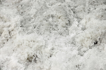 Raging muddy water of a mountain river
