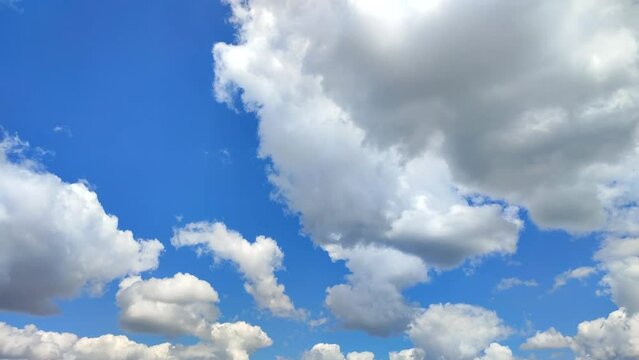 Timelapse. White and gray storm clouds moving quickly across the blue sky. Natural abstract background. Atmosphere, weather. Sunny day. Concept environmental, environmental protection, ecology, eco