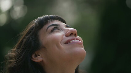 Faithful South American woman closing eyes in meditation looking at sky. Spiritual person opening eye having HOPE