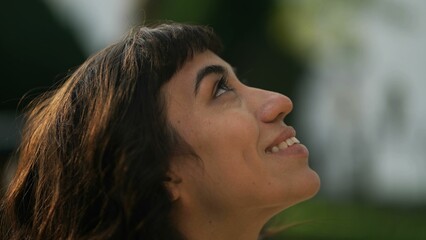 Woman opening eyes to sky having HOPE and FAITH. Spiritual person in contemplation feeling the presence of God and the divine