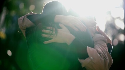 Two best friends reunion. Female friendship hug and embrace. Friends hugging girlfriend outdoors in sunlight. Real life love