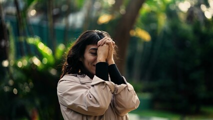 South American woman praying to God being thankful for success