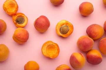 Fresh apricots on pink pastel background