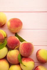 Fresh ripe peaches on pink background, top view. Vertical photo