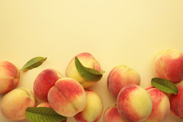 Fresh ripe peaches on beige background, top view.