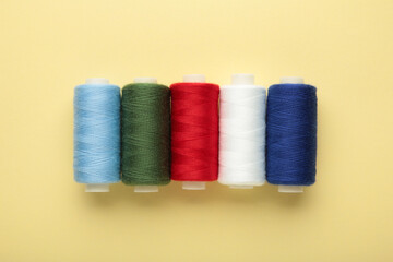 Color sewing threads on beige background