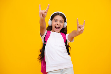 Amazed teen girl. with backpack hold aplle ready to learn. School children with school bag on isolated yellow studio background. Excited expression, cheerful and glad.