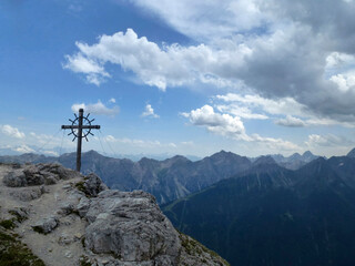Fototapeta na wymiar Summit cross Hoher Burgstall mountain at Stubai high-altitude hiking trail, lap 1 in Tyrol, Austria