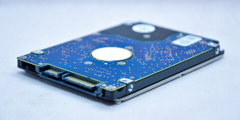 Close-up view of 2.5 inch hard drive seen from the side. and empty on a white background
