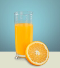 Orange Juice on a color background, in bright light. Glass of Juice with blended orange. Summer tropical cocktail.