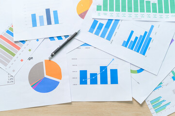 Top view of Documents with analytics data lying on table,selective focus.