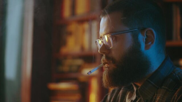 Serious male journalist smoking cigarette, working on article, retro atmosphere
