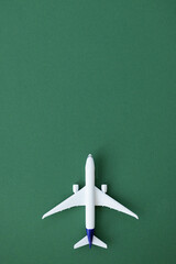 Miniature airplane isolated on green background