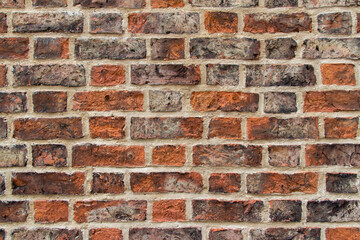 Full frame texture background of a European red and brown color brick wall with a Flemish Bond brickwork pattern