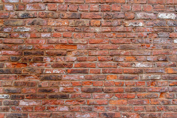 Full frame texture background of an antique European brown and red color brick wall in an Old English Bond brickwork pattern