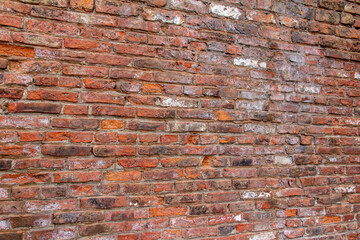 Naklejka premium Full frame texture background of an antique European brown and red color brick wall in an Old English Bond brickwork pattern