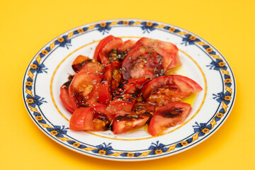 salad with fresh tomato and olive oil on the plate