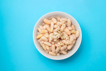 white beans with herbs in small white bowl