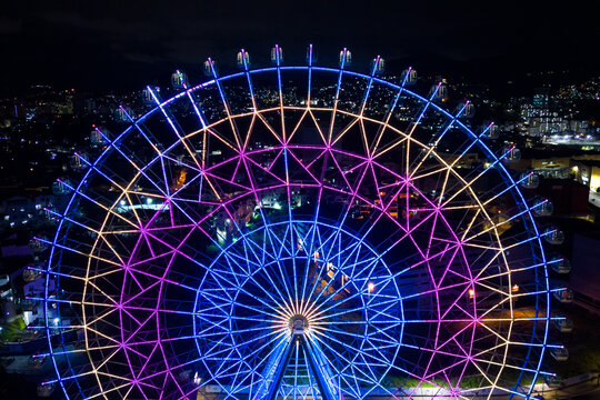 Rio de Janeiro, Brazil - August 3, 2022: Yup Star (Rio Star) ferris wheel at night is illuminated with colorful RGB led lights.