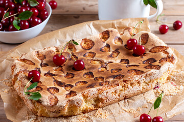Sponge cake or chiffon cake with cherries, so soft and delicious with ingredients on wooden table....