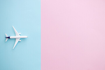 Miniature toy airplane on color background. Trip by airplane.