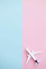 Miniature toy airplane on color background. Trip by airplane.
