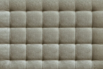 Gray suede leather background for the wall in the room. Interior design, headboards made of furniture fabric, furniture upholstery. Classic checkered pattern for furniture, wall, headboard