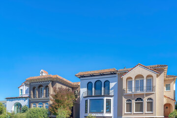 Facade of mediterranean homes with arched doors at the balconies in San Francisco, California