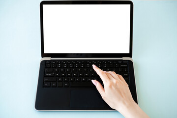 Fototapeta na wymiar Online education. Digital technology. Advertising mockup. Unrecognizable woman typing laptop with blank screen isolated blue.