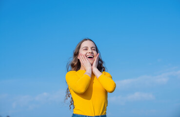 teen girl with beautiful face on sky background