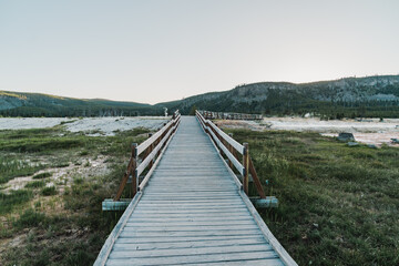 Obraz premium Boardwalk trail through Black Sand Geyser Basin in Yellowstone National Park